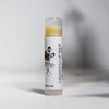 Lip balm tube labeled 'Calendula Lip Balm' on a light background